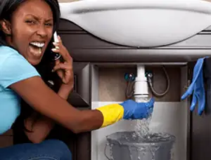 Emergency plumbing repair for a leaking sink drain under a bathroom vanity in Lynchburg, VA
